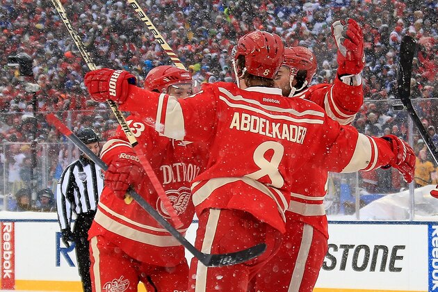 ANN ARBOR, MI - JANUARY 1:  Pavel Datsyuk #13 and Kyle Quincey #27 of the Detroit Red Wings surround teammate Justin Abdelkader #8 after he scored a 3rd period goal to tie it up during the Bridgestone NHL Winter Classic against the Toronto Maple Leafs on January 1, 2014 at the University of Michigan Stadium in Ann Arbor, Michigan. The Toronto Maple Leafs won 3-2 in a shootout (Photo by Dave Reginek/NHLI via Getty Images)