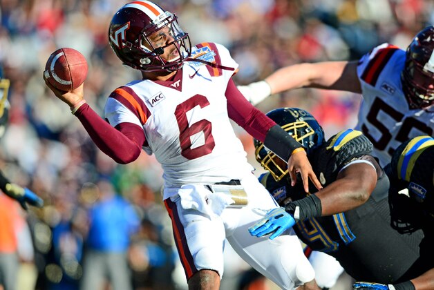 Dec 31, 2013; El Paso, TX, USA; Virginia Tech Hokies quarterback Mark Leal (6) throws the ball away while being pressured out of the pocket by UCLA Bruins defense during the fourth quarter in the 2013 Sun Bowl at Sun Bowl Stadium. Mandatory Credit: Andrew Weber-USA TODAY Sports