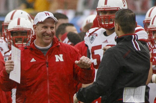Jan 1, 2014; Jacksonville, FL, USA; Nebraska Cornhuskers head coach Bo Pelini celebrates with his staff in the final seconds of the fourth quarter of their game against the Georgia Bulldogs at EverBank Field. The Nebraska Cornhuskers beat the Georgia Bulldogs 24-19. Mandatory Credit: Phil Sears-USA TODAY Sports