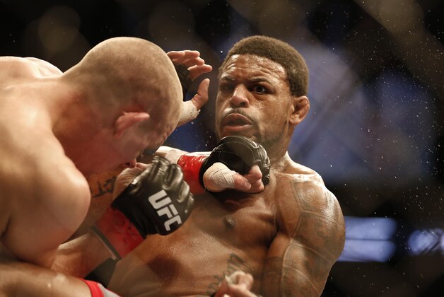 Aug 17, 2013; Boston, MA, USA; Joe Lauzon (left) and Michael Johnson (right) fight during a UFC lightweight match at the TD Garden. Johnson won by judges decision. Mandatory Credit: Winslow Townson-USA TODAY Sports