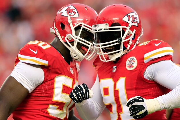 KANSAS CITY, MO - OCTOBER 20:  Outside linebacker Tamba Hali #91 of the Kansas City Chiefs is congratulated by outside linebacker Justin Houston #50 after sacking quarterback Case Keenum #7 of the Houston Texans late in the 2nd half of the game at Arrowhead Stadium on October 20, 2013 in Kansas City, Missouri.  (Photo by Jamie Squire/Getty Images)