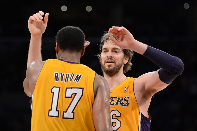 LOS ANGELES, CA - MAY 12:  (R-L) Pau Gasol #16 hugs teammate Andrew Bynum #17 of the Los Angeles Lakers in the fourth quarter while taking on the Denver Nuggets in Game Seven of the Western Conference Quarterfinals in the 2012 NBA Playoffs on May 12, 2012 at Staples Center in Los Angeles, California. NOTE TO USER: User expressly acknowledges and agrees that, by downloading and or using this photograph, User is consenting to the terms and conditions of the Getty Images License Agreement.  (Photo by Harry How/Getty Images)
