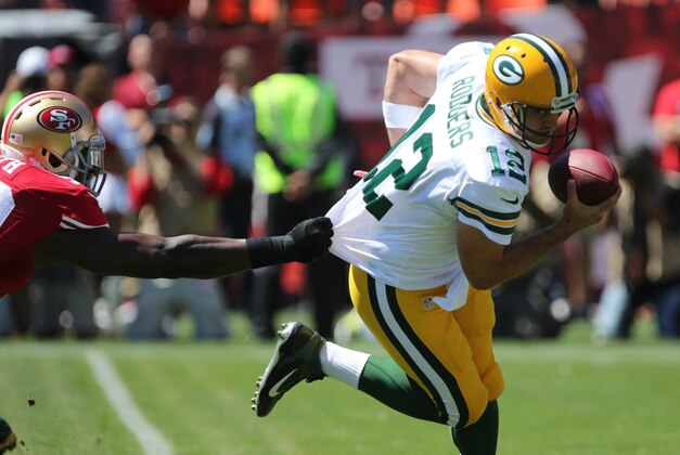 Sep 8, 2013; San Francisco, CA, USA; San Francisco 49ers linebacker Aldon Smith (99) grabs the jersey of Green Bay Packers quarterback Aaron Rodgers (12) forcing a fumble, recovered by Rodgers during the first quarter at Candlestick Park. Mandatory Credit: Kelley L Cox-USA TODAY Sports