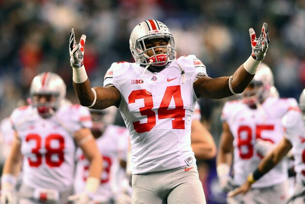 Dec 7, 2013; Indianapolis, IN, USA; Ohio State Buckeyes running back Carlos Hyde (34) pumps up the crowd prior to the 2013 Big 10 Championship game against the Michigan State Spartans at Lucas Oil Stadium. Mandatory Credit: Andrew Weber-USA TODAY Sports