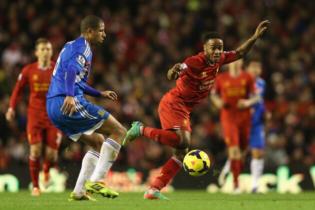 LIVERPOOL, ENGLAND - JANUARY 01: Raheem Sterling of Liverpool in action with Curtis Davies of Hull City during the Barclays Premier League match between Liverpool and Hull City at Anfield on January 1, 2014 in Liverpool, England.  (Photo by Clive Brunskill/Getty Images)