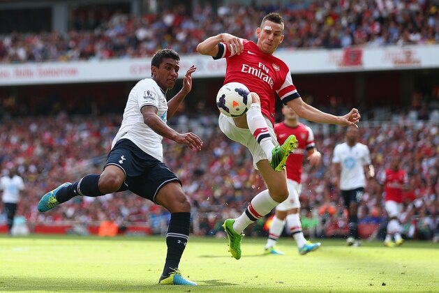 LONDON, ENGLAND - SEPTEMBER 01: Laurent Koscielny of Arsenal is tackled by Paulinho of Tottenham Hotspur during the Barclays Premier League match between Arsenal and Tottenham Hotspur at Emirates Stadium on September 01, 2013 in London, England. (Photo by Clive Mason/Getty Images)