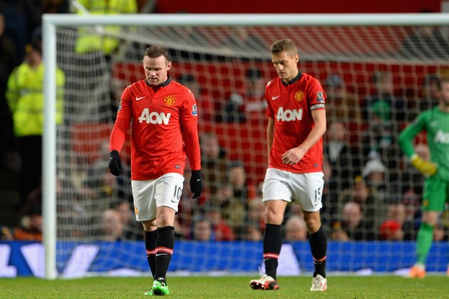 MANCHESTER, ENGLAND - JANUARY 01:  Wayne Rooney of Manchester United and his team-mate Nemanja Vidic (r) react after conceding a second goal during the Barclays Premier League match between Manchester United and Tottenham Hotspur at Old Trafford on January 1, 2014 in Manchester, England.  (Photo by Michael Regan/Getty Images)