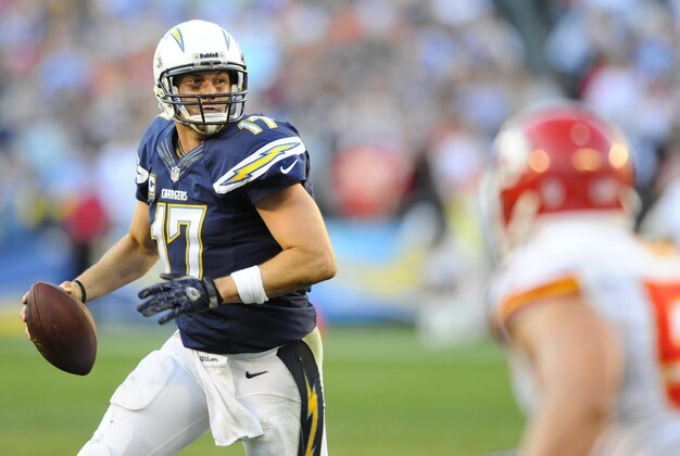 Dec 29, 2013; San Diego, CA, USA; San Diego Chargers quarterback Philip Rivers (17) rolls out of the pocket in overtime against the Kansas City Chiefs at Qualcomm Stadium. The Chargers won 27-24 in overtime. Mandatory Credit: Christopher Hanewinckel-USA TODAY Sports