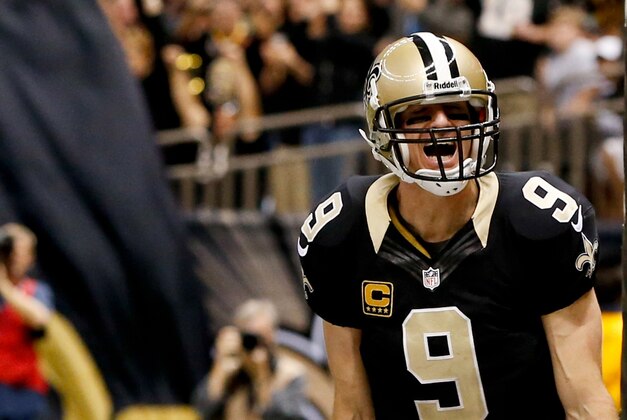 Dec 29, 2013; New Orleans, LA, USA; New Orleans Saints quarterback Drew Brees (9) celebrates a touchdown run against the Tampa Bay Buccaneers during the fourth quarter of a game at the Mercedes-Benz Superdome.The Saints defeated the Buccaneers 42-17. Mandatory Credit: Derick E. Hingle-USA TODAY Sports