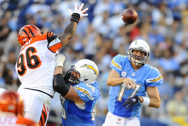 Dec 1, 2013; San Diego, CA, USA; San Diego Chargers quarterback Philip Rivers (17) throws over the reach of Cincinnati Bengals defensive end Carlos Dunlap (96) during the second half at Qualcomm Stadium. The Bengals won 17-10. Mandatory Credit: Christopher Hanewinckel-USA TODAY Sports