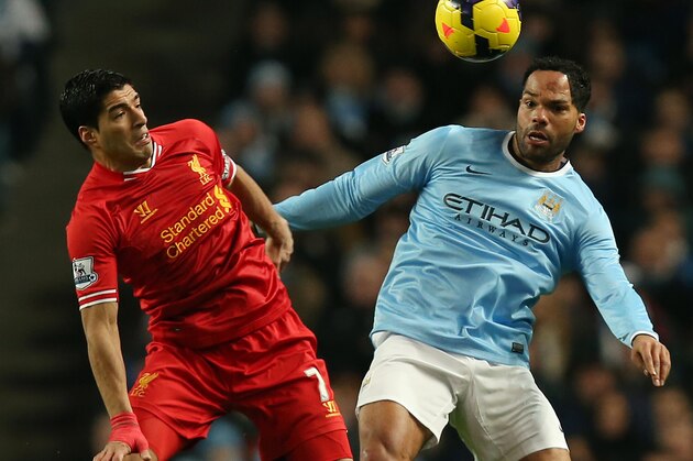 MANCHESTER, ENGLAND - DECEMBER 26:  Luis Suarez of Liverpool battles with Joleon Lescott of Manchester City during the Barclays Premier League match between Manchester City and Liverpool at the Etihad Stadium on December 26, 2013 in Manchester, England.  (Photo by Jan Kruger/Getty Images)