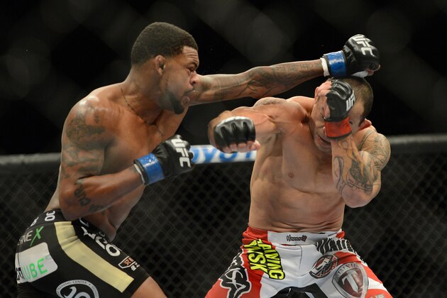 Dec 28, 2013; Las Vegas, NV, USA;    Gleison Tibau (red gloves) and Michael Johnson (blue gloves) fight during their UFC featherweight bout at the MGM Grand Garden Arena. Mandatory Credit: Jayne Kamin-Oncea-USA TODAY Sports