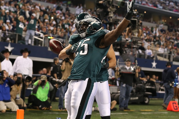 Dec 29, 2013; Arlington, TX, USA; Philadelphia Eagles running back LeSean McCoy (25) celebrates his second quarter touchdown with receiver Riley Cooper (14) against the Dallas Cowboys at AT&T Stadium. Mandatory Credit: Matthew Emmons-USA TODAY Sports