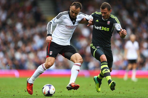 LONDON, ENGLAND - OCTOBER 05:  Dimitar Berbatov of Fulham takes on Erik Pieters of Stoke City during the Barclays Premier League match between Fulham and Stoke City at Craven Cottage on October 5, 2013 in London, England.  (Photo by Paul Gilham/Getty Images)
