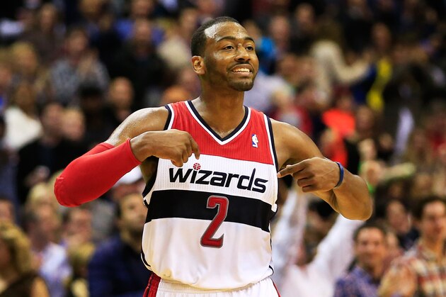 WASHINGTON, DC - DECEMBER 06:  John Wall #2 of the Washington Wizards celebrates after making a basket during the closing mintues of regulation against the Milwaukee Bucks at Verizon Center on December 6, 2013 in Washington, DC. The Bucks won 109-105. NOTE TO USER: User expressly acknowledges and agrees that, by downloading and or using this photograph, User is consenting to the terms and conditions of the Getty Images License Agreement.  (Photo by Rob Carr/Getty Images)
