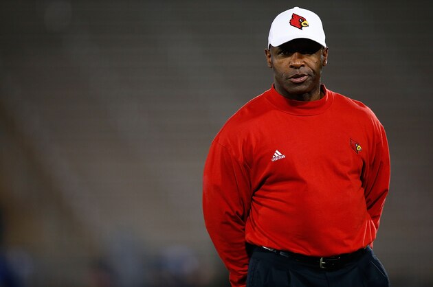 EAST HARTFORD, CT - NOVEMBER 08:  Head coach Charlie Strong of the Louisville Cardinals watches his team warm up prior to the game against the Connecticut Huskies at Rentschler Field on November 8, 2013 in East Hartford, Connecticut.  (Photo by Jared Wickerham/Getty Images)