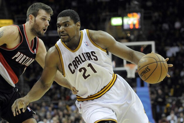 Dec 17, 2013; Cleveland, OH, USA; Cleveland Cavaliers center Andrew Bynum (21) drives against Portland Trail Blazers center Joel Freeland (19) in the fourth quarter at Quicken Loans Arena. Mandatory Credit: David Richard-USA TODAY Sports