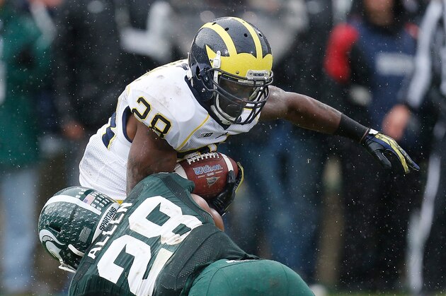 EAST LANSING, MI - NOVEMBER 02: Denicos Allen #28 of the Michigan State Spartans brings down Fitzgerald Toussaint #28 of the Michigan Wolverines in the second quarter  at Spartan Stadium on November 2, 2013 in East Lansing, Michigan. (Photo by Gregory Shamus/Getty Images)