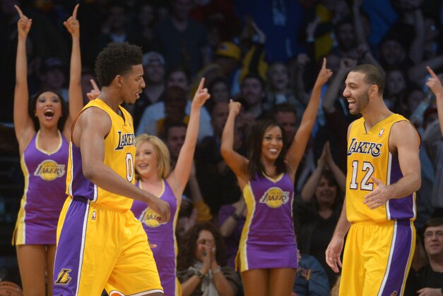 Jan 3, 2014; Los Angeles, CA, USA; Los Angeles Lakers guards Nick Young (0) and Kendall Marshall (20) celebrate in the final minute against the Utah Jazz at Staples Center. The Lakers defeated the Jazz 110-99. Mandatory Credit: Kirby Lee-USA TODAY Sports