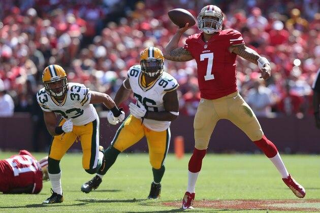 SAN FRANCISCO, CA - SEPTEMBER 08:  Quarterback Colin Kaepernick #7 of the San Francisco 49ers is pursued by Micah Hyde #33 and Mike Neal #96 of the Green Bay Packers at Candlestick Park on September 8, 2013 in San Francisco, California.  (Photo by Jeff Gross/Getty Images)