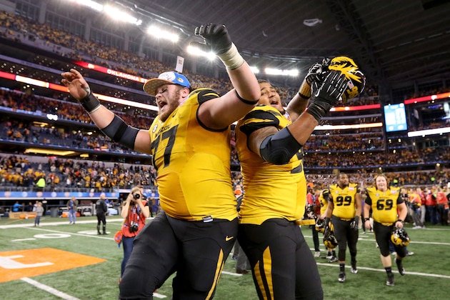 ARLINGTON, TX - JANUARY 03:  Evan Boehm #77 and Lucas Vincent #96 of the Missouri Tigers celebrates the Tigers 41-31 victory against the Oklahoma State Cowboys during the AT&T Cotton Bowl on January 3, 2014 in Arlington, Texas.  (Photo by Ronald Martinez/Getty Images)