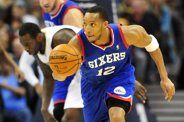 Jan 1, 2014; Denver, CO, USA; Philadelphia 76ers forward Evan Turner (12) dribbles up the court in the third quarter against the Denver Nuggets at Pepsi Center.  Philadelphia won 114-102. Mandatory Credit: Byron Hetzler-USA TODAY Sports