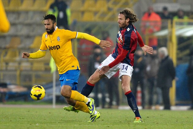 BOLOGNA, ITALY - DECEMBER 06: Mirko Vucinic #9 of Juventus ( L ) competes for the ball with Cesare Natali # 14 of Bologna FC ( R ) during the Serie A match between Bologna FC and Juventus at Stadio Renato Dall'Ara on December 6, 2013 in Bologna, Italy.  (Photo by Mario Carlini / Iguana Press/Getty Images)