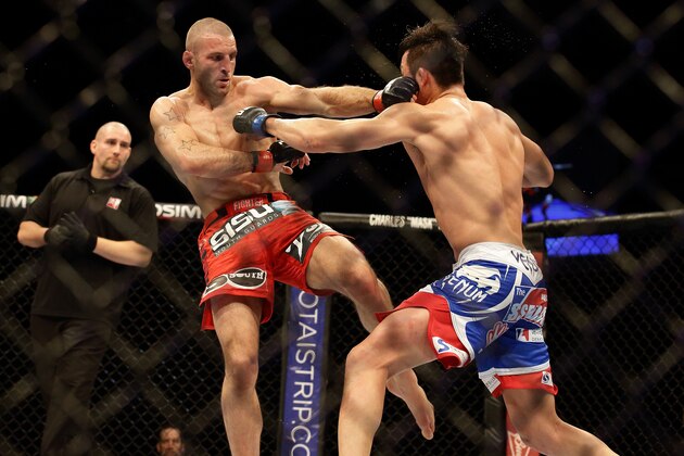 SINGAPORE - JANUARY 04:  Tarec Saffiedine (L) fights Lim Hyun Gyu during their UFC Fight Night Singapore welterweight bout at Marina Bay Sands on January 4, 2014 in Singapore.  (Photo by Suhaimi Abdullah/Getty Images)