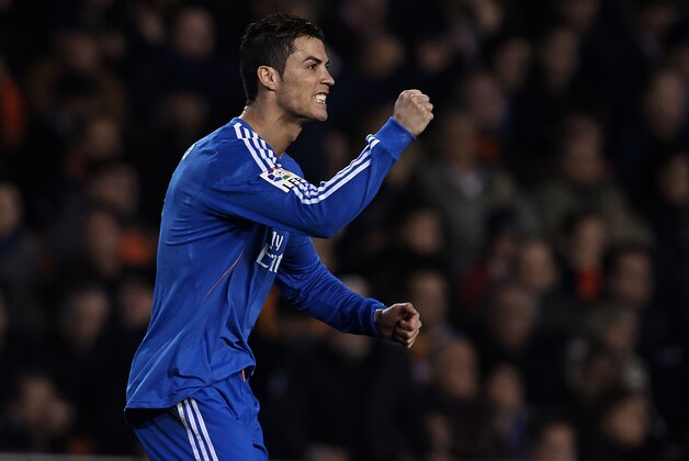 VALENCIA, SPAIN - DECEMBER 22:  Cristiano Ronaldo of Real Madrid celebrates after scoring during the La Liga match between Valencia CF and Real Madrid CF at Estadio Mestalla on December 22, 2013 in Valencia, Spain.  (Photo by Manuel Queimadelos Alonso/Getty Images)