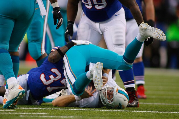 ORCHARD PARK, NY - DECEMBER 22:  Ryan Tannehill #17 of the Miami Dolphins is sacked by  Nickell Robey #37 of the Buffalo Bills at Ralph Wilson Stadium on December 22, 2013 in Orchard Park, New York. Buffalo won 16-0.  (Photo by Rick Stewart/Getty Images)