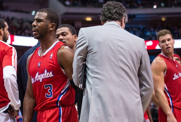 Jan 3, 2014; Dallas, TX, USA; Los Angeles Clippers point guard Chris Paul (3) leaves the court during the second half against the Dallas Mavericks at the American Airlines Center. Paul sprains his right shoulder and does not return to the game. The Clippers defeated the Mavericks 119-112. Mandatory Credit: Jerome Miron-USA TODAY Sports