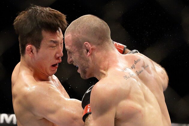 SINGAPORE - JANUARY 04:  Tarec Saffiedine (R) fights Lim Hyun Gyu during their UFC Fight Night Singapore welterweight bout at Marina Bay Sands on January 4, 2014 in Singapore.  (Photo by Suhaimi Abdullah/Getty Images)