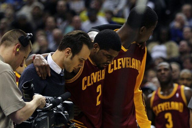 Dec 31, 2013; Indianapolis, IN, USA;  Cleveland Cavaliers point guard Kyrie Irving (2) is helped off the court after being injured during the third quarter against the Indiana Pacers at Bankers Life Fieldhouse. The Pacers won 91-76.  Mandatory Credit: Pat Lovell-USA TODAY Sports
