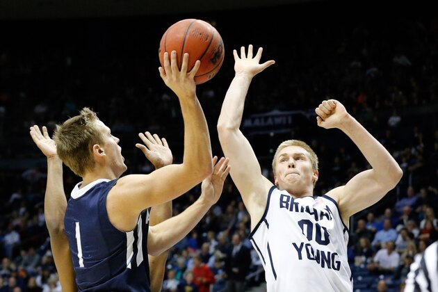 Jan 4, 2014; Provo, UT, USA; San Diego Toreros guard Johnny Dee (1) shoots the ball while Brigham Young Cougars forward Eric Mika (00) tries to block the shot during the first half at Marriott Center. Mandatory Credit: Chris Nicoll-USA TODAY Sports