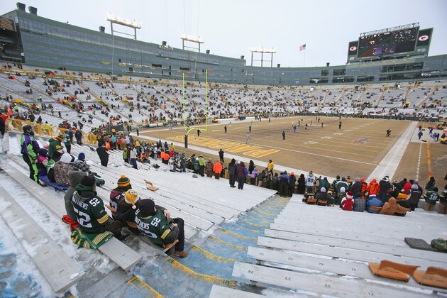 GREEN BAY, WI - DECEMBER 22: Fans of the Green Bay Packers watch a game on the view screen as players come out for warm-ups before a game between the Packers and the Pittsburgh Steelers at Lambeau Field on December 22, 2013 in Green Bay, Wisconsin.  (Photo by Jonathan Daniel/Getty Images)