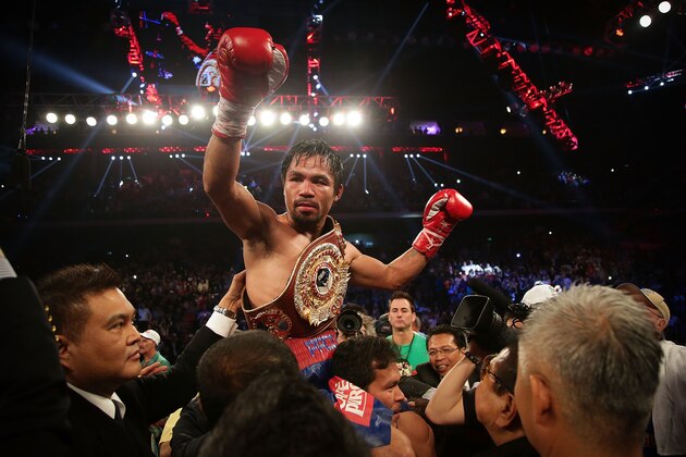 MACAU - NOVEMBER 24:  Manny Pacquiao of the Philippines celebrates winning against Brandon Rios of the U.S. during their 'Clash in Cotai' WBO International Welterweight title fight on November 24, 2013 in Macau.  (Photo by Nicky Loh/Getty Images)