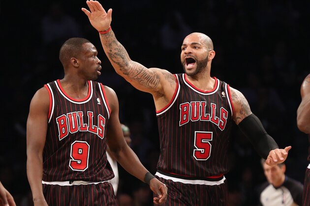 NEW YORK, NY - APRIL 04: Luol Deng #9 and Carlos Boozer #5 of the Chicago Bulls play against the Brooklyn Nets at the Barclays Center on April 4, 2013 in New York City. NOTE TO USER: User expressly acknowledges and agrees that, by downloading and/or using this photograph, user is consenting to the terms and conditions of the Getty Images License Agreement.  (Photo by Bruce Bennett/Getty Images)
