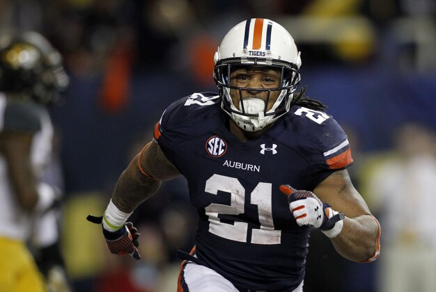 Dec 7, 2013; Atlanta, GA, USA; Auburn Tigers running back Tre Mason (21) celebrates after a touchdown against the Missouri Tigers during the fourth quarter of the 2013 SEC Championship game at Georgia Dome. Auburn won 59-42. Mandatory Credit: Brett Davis-USA TODAY Sports