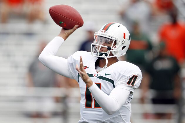 Sep 1, 2012; Chestnut Hill, Massachusetts, USA; Miami Hurricanes quarterback Ryan Williams (11) makes a pass during warm-ups before the game against the Boston College Eagles at Alumni Stadium.   Mandatory Credit: Greg M. Cooper-USA TODAY Sports