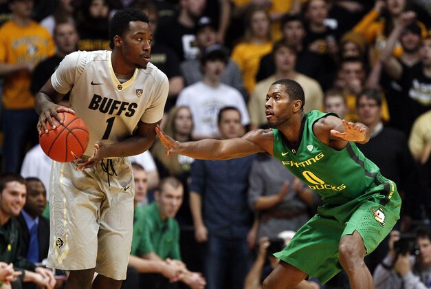 Jan 5, 2014; Boulder, CO, USA; Oregon Ducks forward Mike Moser (0) defends Colorado Buffaloes forward Wesley Gordon (1) in the first half at Coors Events Center. Mandatory Credit: Isaiah J. Downing-USA TODAY Sports