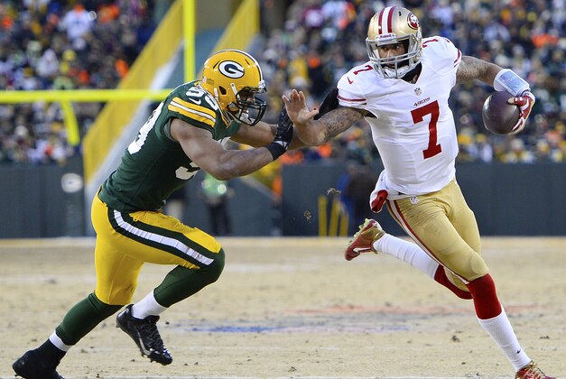 Jan 5, 2014; Green Bay, WI, USA; San Francisco 49ers quarterback Colin Kaepernick (7) runs with the ball as Green Bay Packers inside linebacker Brad Jones (59) attempts to tackle during the first quarter of the 2013 NFC wild card playoff football game at Lambeau Field. Mandatory Credit: Mike DiNovo-USA TODAY Sports