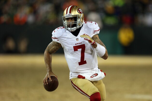 GREEN BAY, WI - JANUARY 05:  Colin Kaepernick #7 of the San Francisco 49ers runs the ball for a first down in the fourth quarter against the Green Bay Packers during their NFC Wild Card Playoff game at Lambeau Field on January 5, 2014 in Green Bay, Wisconsin.  (Photo by Jonathan Daniel/Getty Images)
