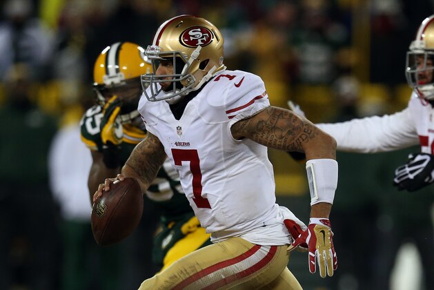 GREEN BAY, WI - JANUARY 05:  Colin Kaepernick #7 of the San Francisco 49ers runs the ball against the Green Bay Packers during their NFC Wild Card Playoff game at Lambeau Field on January 5, 2014 in Green Bay, Wisconsin.  (Photo by Jonathan Daniel/Getty Images)