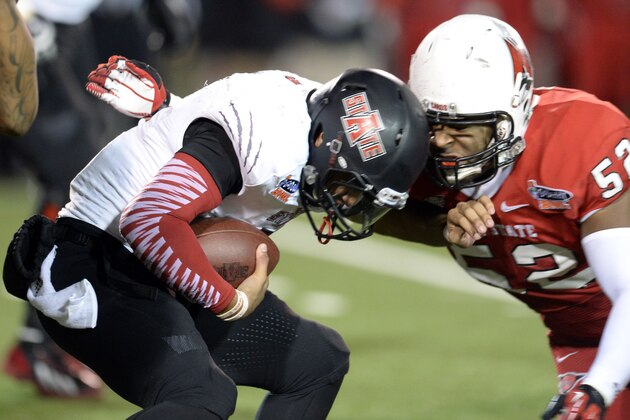 Jan 5, 2014; Mobile, AL, USA;  Arkansas State Red Wolves linebacker Quanterio Heath (52) gets wrapped up by Ball State Cardinals defensive end Nick Miles (52) during the fourth quarter at Ladd-Peebles Stadium. Mandatory Credit: John David Mercer-USA TODAY Sports