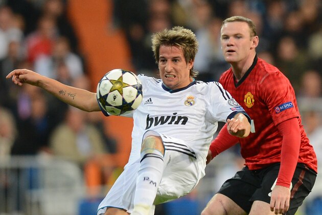 MADRID, SPAIN - FEBRUARY 13:  Fabio Coentrao of Real Madrid is shadowed by Wayne Rooney of Manchester United during the UEFA Champions League Round of 16 first leg match between Real Madrid and Manchester United at Estadio Santiago Bernabeu on February 13, 2013 in Madrid, Spain.  (Photo by Mike Hewitt/Getty Images)