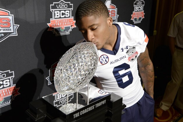NEWPORT BEACH, CA - JANUARY 4:  Jonathan Mincy #6  of the Auburn Tigers kisses The Coaches Trophy during the Vizio BCS National Championship media day January 4, 2014 in Newport Beach, California.  (Photo by Kevork Djansezian/Getty Images)