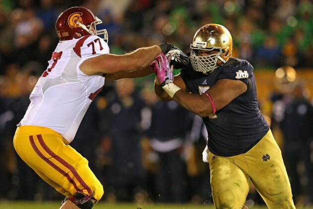 SOUTH BEND, IN - OCTOBER 19: Stephon Tuitt #7 of the Notre Dame Fighting Irish rushes against Kevin Graf #77 of the University of Southern California Trojans at Notre Dame Stadium on October 19, 2013 in South Bend, Indiana. Notre Dame defeated USC 14-10.  (Photo by Jonathan Daniel/Getty Images)