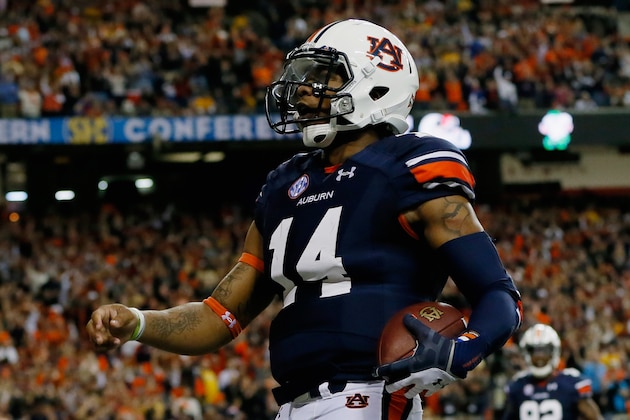 ATLANTA, GA - DECEMBER 07:  Quarterback Nick Marshall #14 of the Auburn Tigers celebrates scoring a touchdown in the first quarter against the Missouri Tigers during the SEC Championship Game at Georgia Dome on December 7, 2013 in Atlanta, Georgia.  (Photo by Kevin C. Cox/Getty Images)
