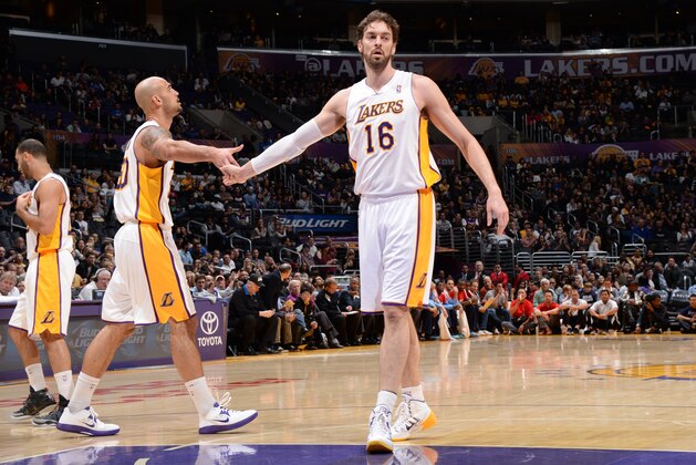 LOS ANGELES, CA - JANUARY 5: Robert Sacre #50 and Pau Gasol #16 of the Los Angeles Lakers celebrate during a game against the Denver Nuggets at STAPLES Center on January 5, 2014 in Los Angeles, California. NOTE TO USER: User expressly acknowledges and agrees that, by downloading and/or using this Photograph, user is consenting to the terms and conditions of the Getty Images License Agreement. Mandatory Copyright Notice: Copyright 2014 NBAE (Photo by Andrew D. Bernstein/NBAE via Getty Images)