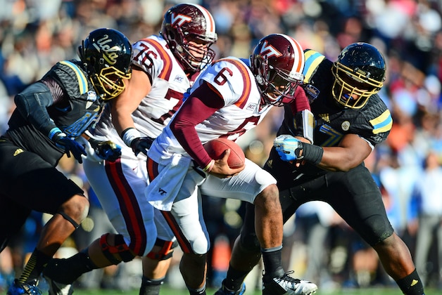 Dec 31, 2013; El Paso, TX, USA; Virginia Tech Hokies quarterback Mark Leal (6) is pressured out of the pocket by UCLA Bruins defense during the fourth quarter in the 2013 Sun Bowl at Sun Bowl Stadium. Mandatory Credit: Andrew Weber-USA TODAY Sports